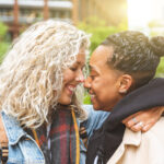 Happy multiracial girlfriend in loving embrace